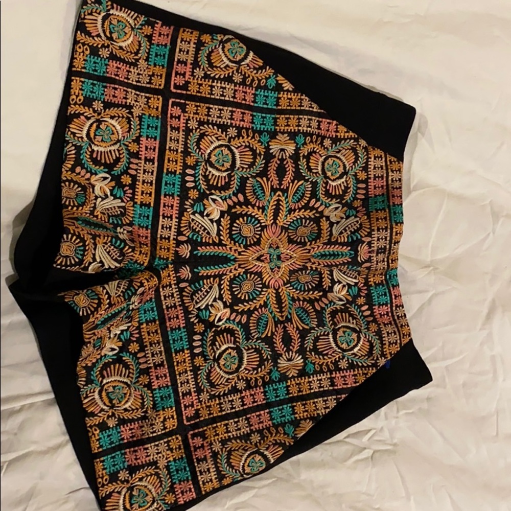 Embroidered black shorts.